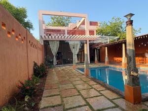 a villa with a swimming pool and a house at Villa Saffron Luxury Pvt Pool in Pondicherry