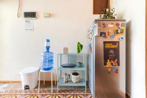 a refrigerator in a kitchen with a shelf next to it at Casa Donderis in Santo Domingo +31 photos