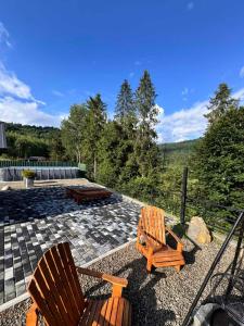 two chairs and a table on a patio at Chalet Tukhlya in Tukhlya