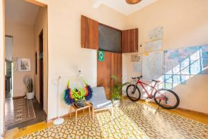 a living room with a bike and a room with a wall at Casa Donderis in Santo Domingo