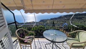 a table and chairs on a balcony with a view of the ocean at Sette Isole Countryside Retreat Near Egremni Beach Studio 1 in Athani