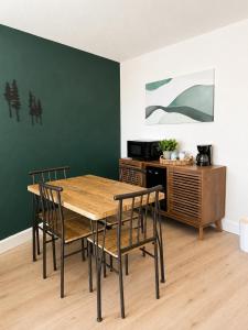 a dining room with a wooden table and chairs at Kiva Motel in Show Low