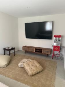 a living room with a flat screen tv on a wall at Villa Ljeto in Pupnatska Luka