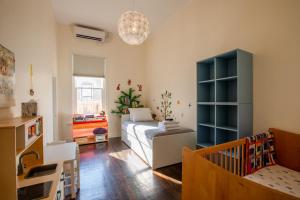 a small room with a bed and a crib at Kid-Friendly Stay with Backyard: Long Stays in Salt Lake City