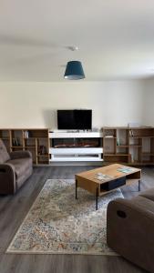 a living room with a couch and a coffee table at Dwellinghouse, Inishmore in Ourtnagapple