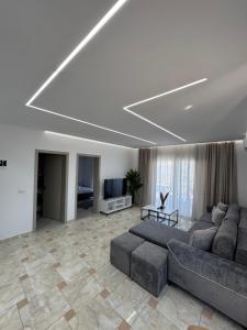 a living room with a couch and a television at Villa Merkaj in Sarandë