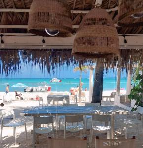 a restaurant with a table and chairs on the beach at Beach Veranda Hotel Punta Cana in Punta Cana