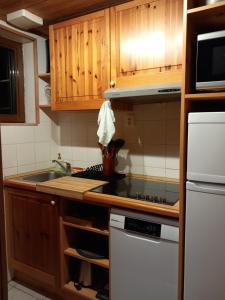 a kitchen with a sink and a stove top oven at Les chalets d Evian in Évian-les-Bains