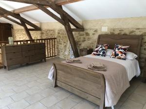 a bedroom with a large bed and a dresser at Gîte La Carole 120m2 in Monlezun +26 photos