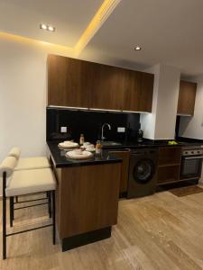 a kitchen with a sink and a dishwasher at Triple Tower 23eme étage La vue 329 gare tgv & plage 3min in Tangier