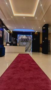 a red carpet in a room with a red rug at sala almasa serviced apartments in Abha