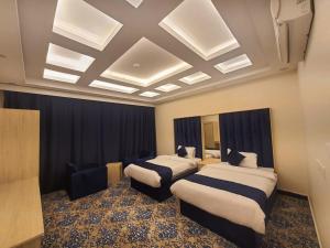 a hotel room with two beds and a ceiling at sala almasa serviced apartments in Abha +47 photos
