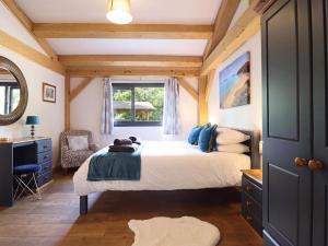 a bedroom with a bed and a window at Lady Bagots Cabin in Ruthin