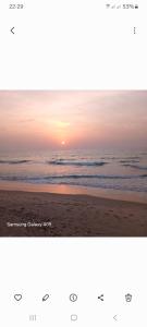 a picture of a beach with the sun setting at J'adore House in Abémé