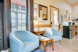 a living room with two chairs and a table at Cute Studio Cabin Steps to Long Beach Boardwalk in Long Beach