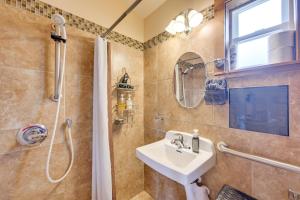 a bathroom with a sink and a shower at Cute Studio Cabin Steps to Long Beach Boardwalk in Long Beach +21 photos