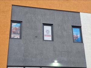 a building with three windows on the side of it at Apartman za 6 osoba BOR in Bor
