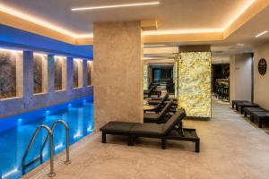 a hotel lobby with a swimming pool and a waiting room at Spatium Medical & Wellness Hotel in Odesa