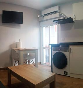 a living room with a table and a kitchen at Apartamento El Centro in Algarrobo +15 photos