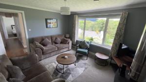 a living room with a couch and a table at Donrae in Portree