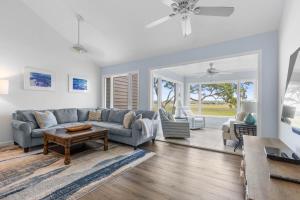 a living room with a couch and a table at 1211 Creekwatch Villa in Seabrook Island