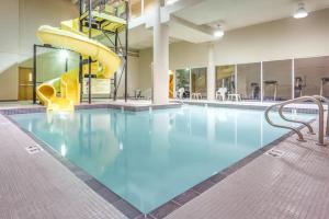 a swimming pool with a slide in a building at Super 8 by Wyndham Abbotsford BC in Abbotsford