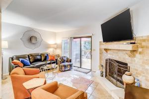 a living room with a couch and a fireplace at Beachwalk 124 in Hilton Head Island