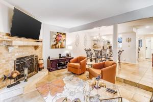 a living room with a fireplace and a tv at Beachwalk 124 in Hilton Head Island
