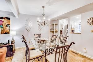 a dining room with a glass table and chairs at Beachwalk 124 in Hilton Head Island +26 photos