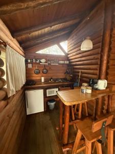 a kitchen with a wooden table in a cabin at Cabañas Los Troncos in San Pedro