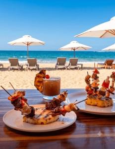 two plates of food on a table at the beach at Posada Las Rosas Inn in Quizandal