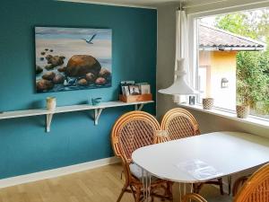 a dining room with a white table and chairs at 4 person holiday home in Allinge in Allinge