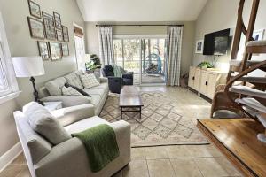 a living room with a couch and a table at Firefly Cottage in Edisto Beach