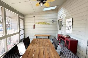 a dining room with a wooden table and chairs at Firefly Cottage in Edisto Beach