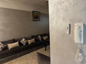 a living room with a couch and a phone at Cozy Appartement for vacation in Agadir