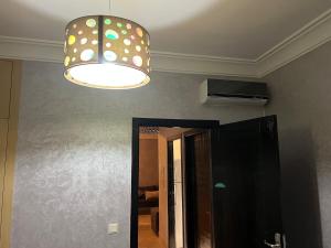 a ceiling light and a mirror in a room at Cozy Appartement for vacation in Agadir