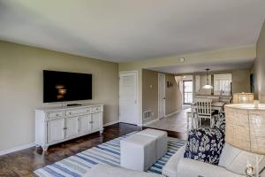 a living room with a couch and a tv at Courtside 56 in Hilton Head Island