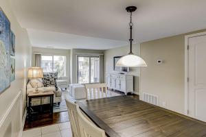 a dining room and living room with a dining table at Courtside 56 in Hilton Head Island