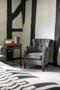a living room with a chair and a side table at The Windmill in Maidstone