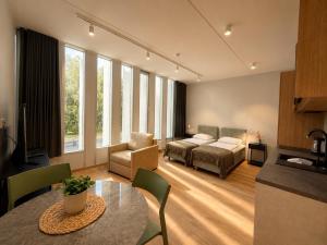 a living room with a table and a couch and a bed at Emajõe Apartments in Tartu