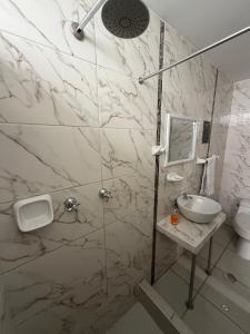 a bathroom with a shower and a sink at Chikan Hoteles in Arequipa +39 photos