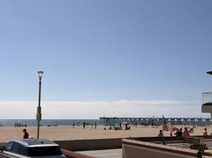 a car parked on a beach with a pier at The Vurpillat in Hermosa Beach