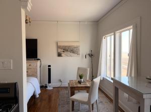a bedroom with a bed and a desk with a chair at The Vurpillat in Hermosa Beach