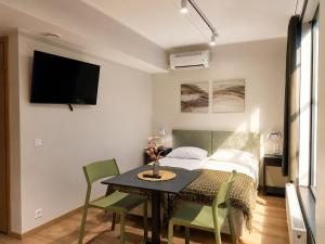 a room with a bed and a table and chairs at Emajõe Apartments in Tartu
