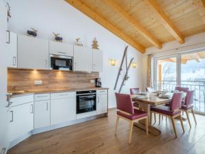 a kitchen and dining room with a table and chairs at Hochkönigblick I in Werfenweng