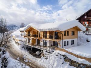 a wooden house covered in snow with snow at Hochkönigblick I in Werfenweng