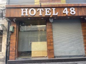a hotel sign on the front of a building at Hotel 48 in Amritsar +4 photos
