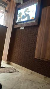 a television on the wall of a room at Hotel 48 in Amritsar