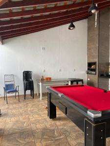 a pool table in a room with a ping pong ball at Recanto Peixoto in Olímpia