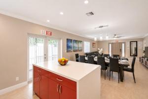 a kitchen and dining room with a table and chairs at Walk to Hollywood Beach Luxury 4BR Villa in Hollywood